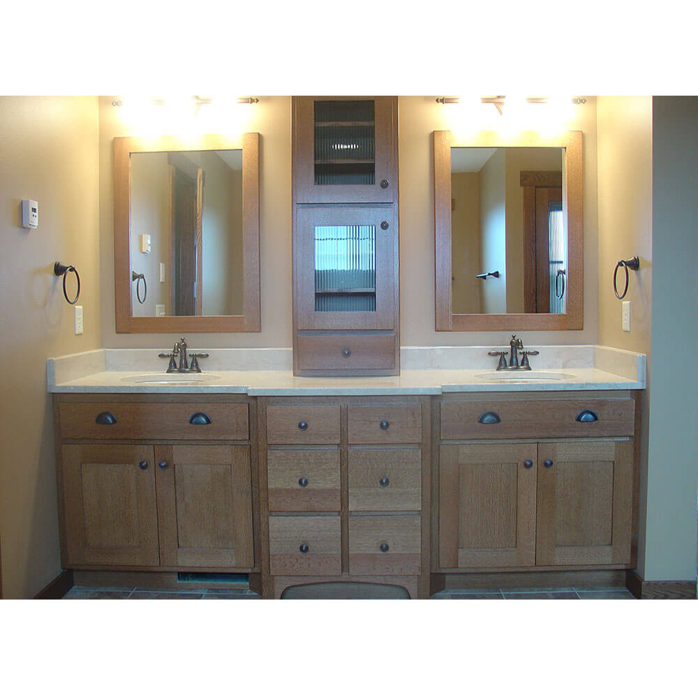 Light brown bathroom with two sinks in a white granite countertop