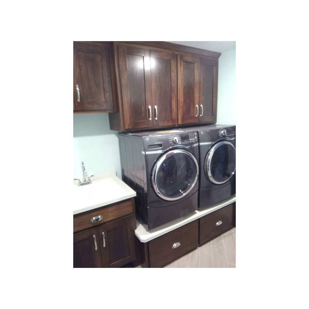 Black washer and dryer with dark wood cabinets