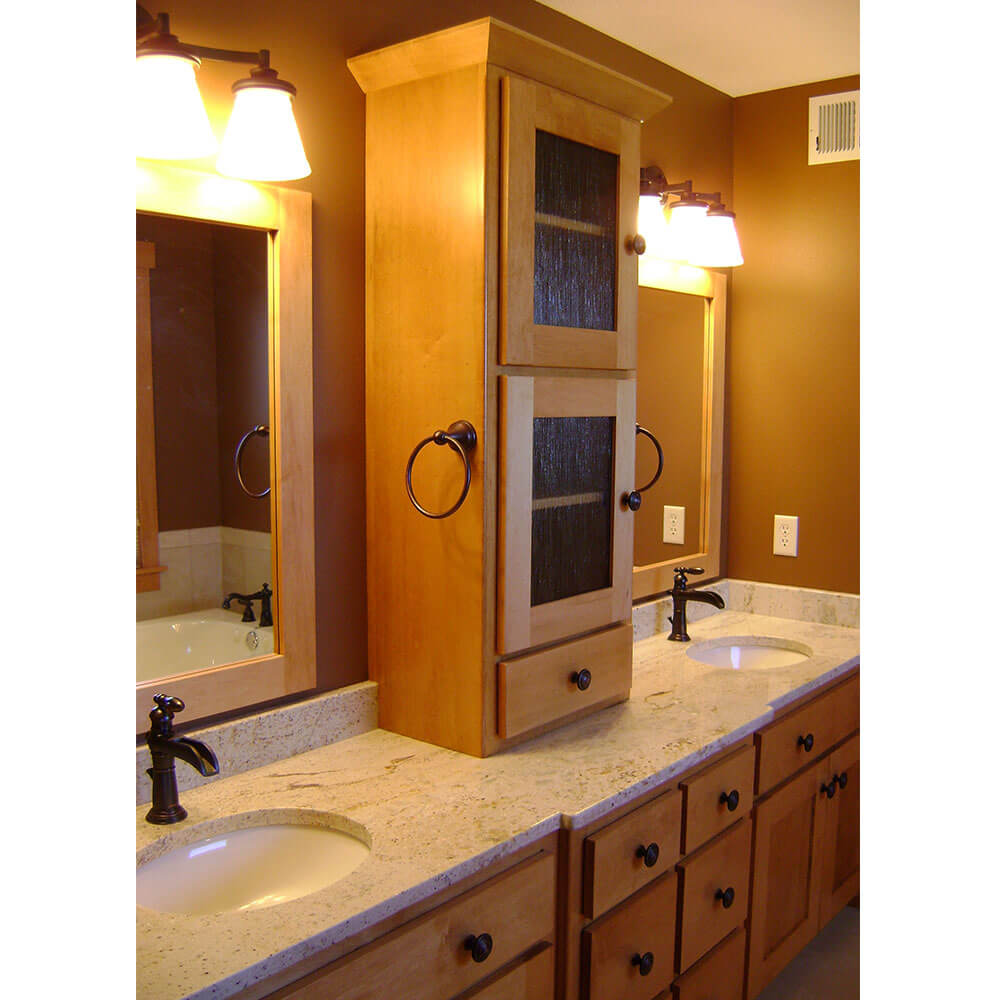 Bathroom with two sinks and a cabinet between