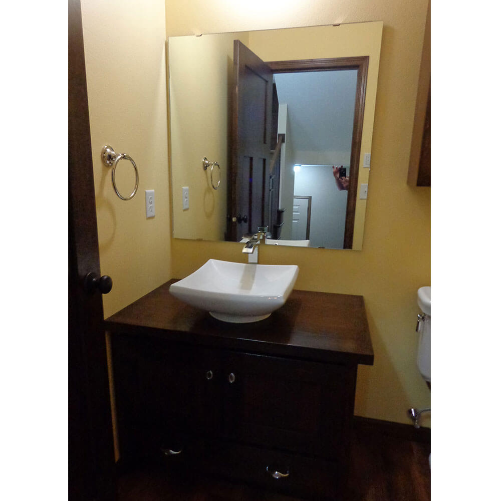 White square shaped sink with a dark brown cabinet