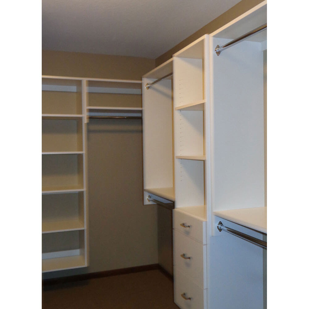 A White closet unit with a dark wood floor