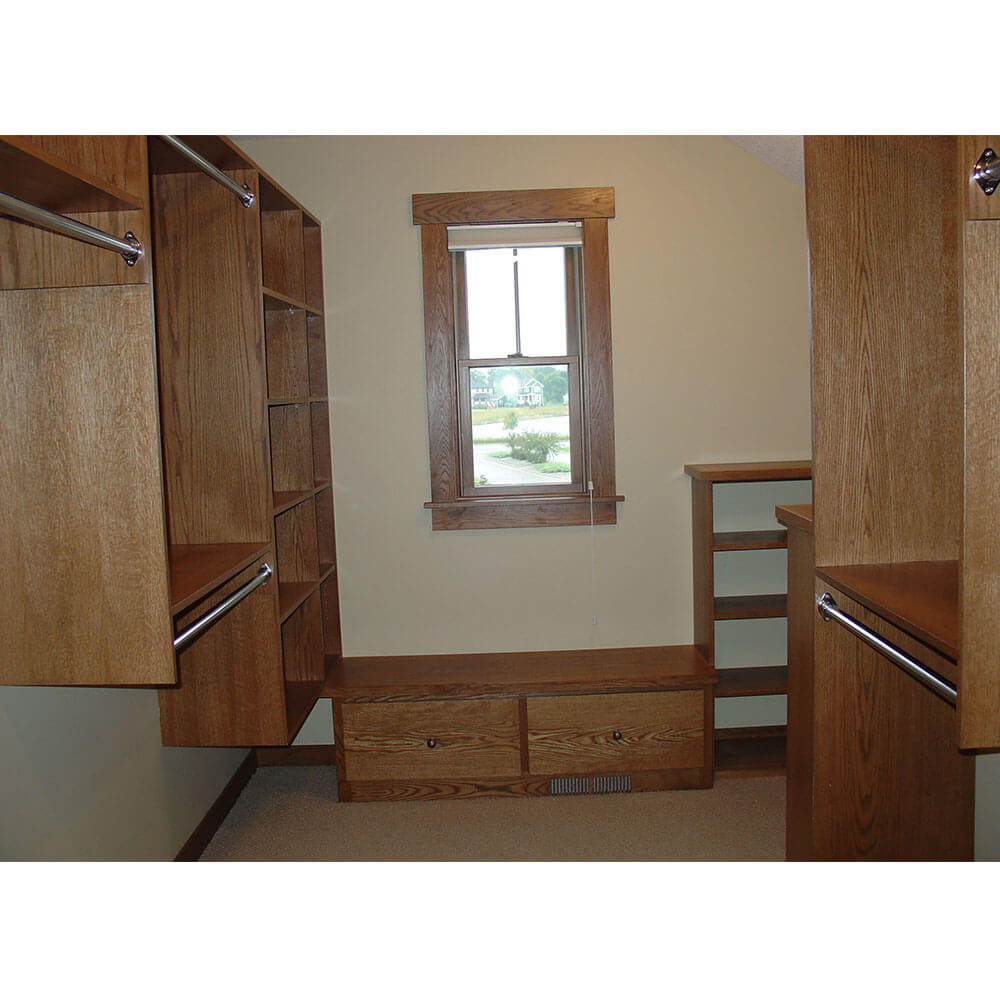 A walk-in closet with various sized shelving units