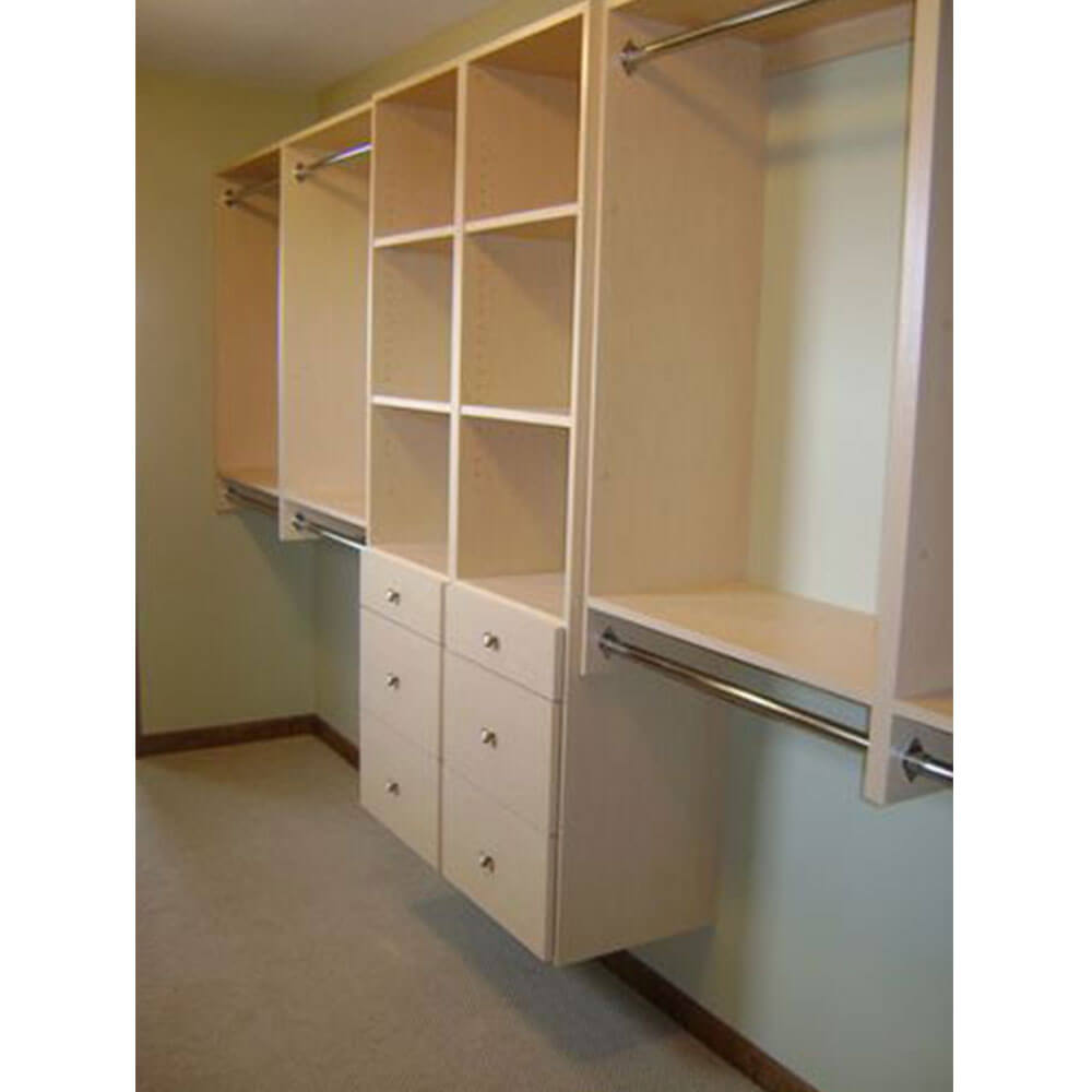 A shelving unit made of light colored wood in a walk-in closet