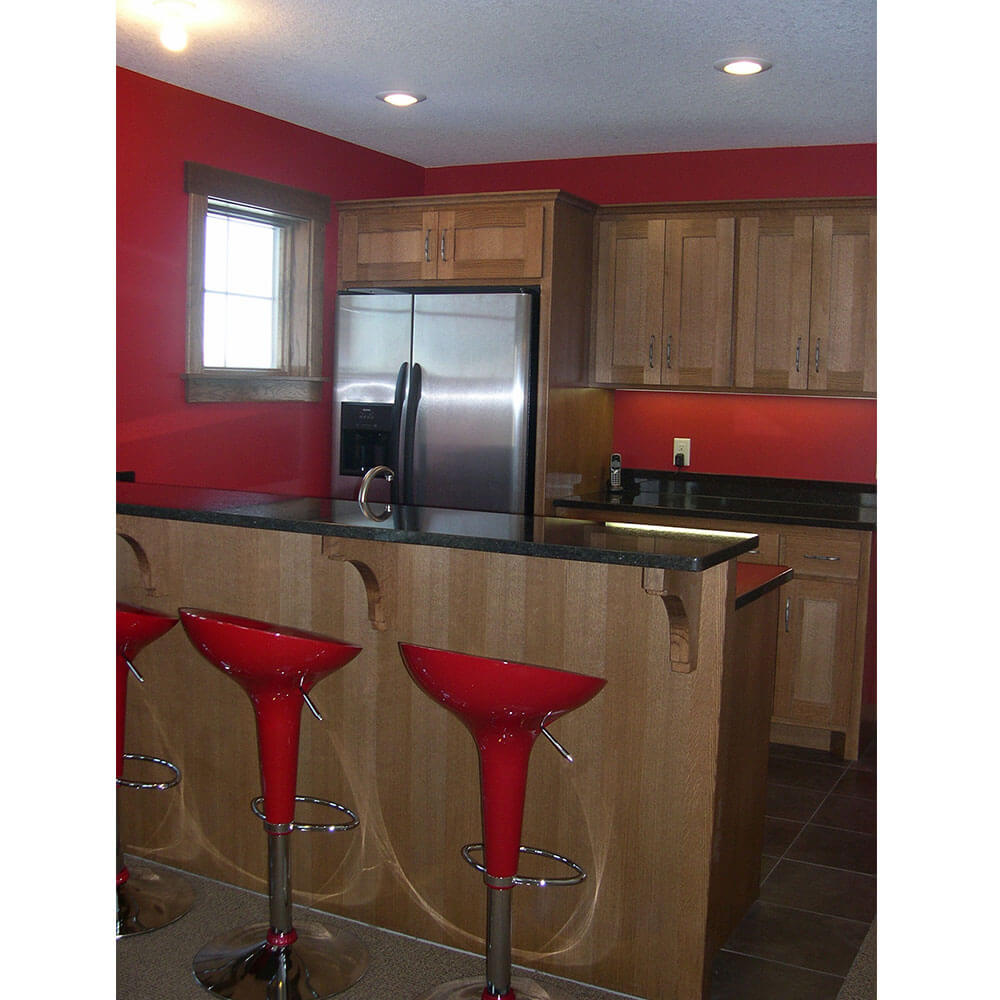 A beverage bar with a black counter with red barstools