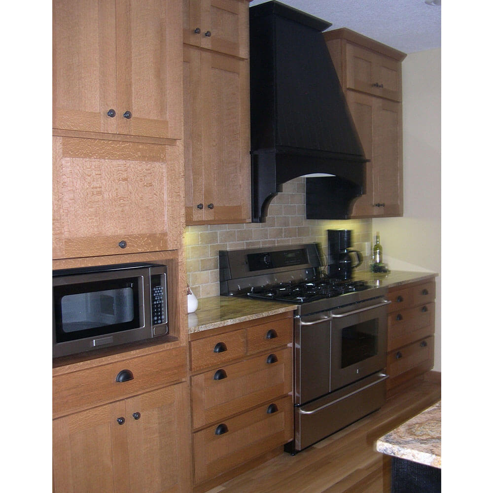 Wooden cabinets and counter with a silver oven