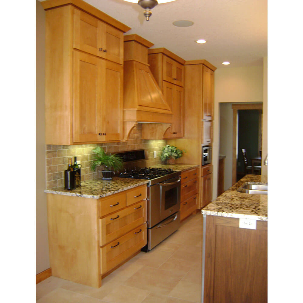 A kitchen with light wooden cabinets