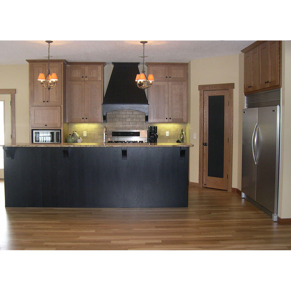 A full kitchen with hardwood floors and custom cabinets