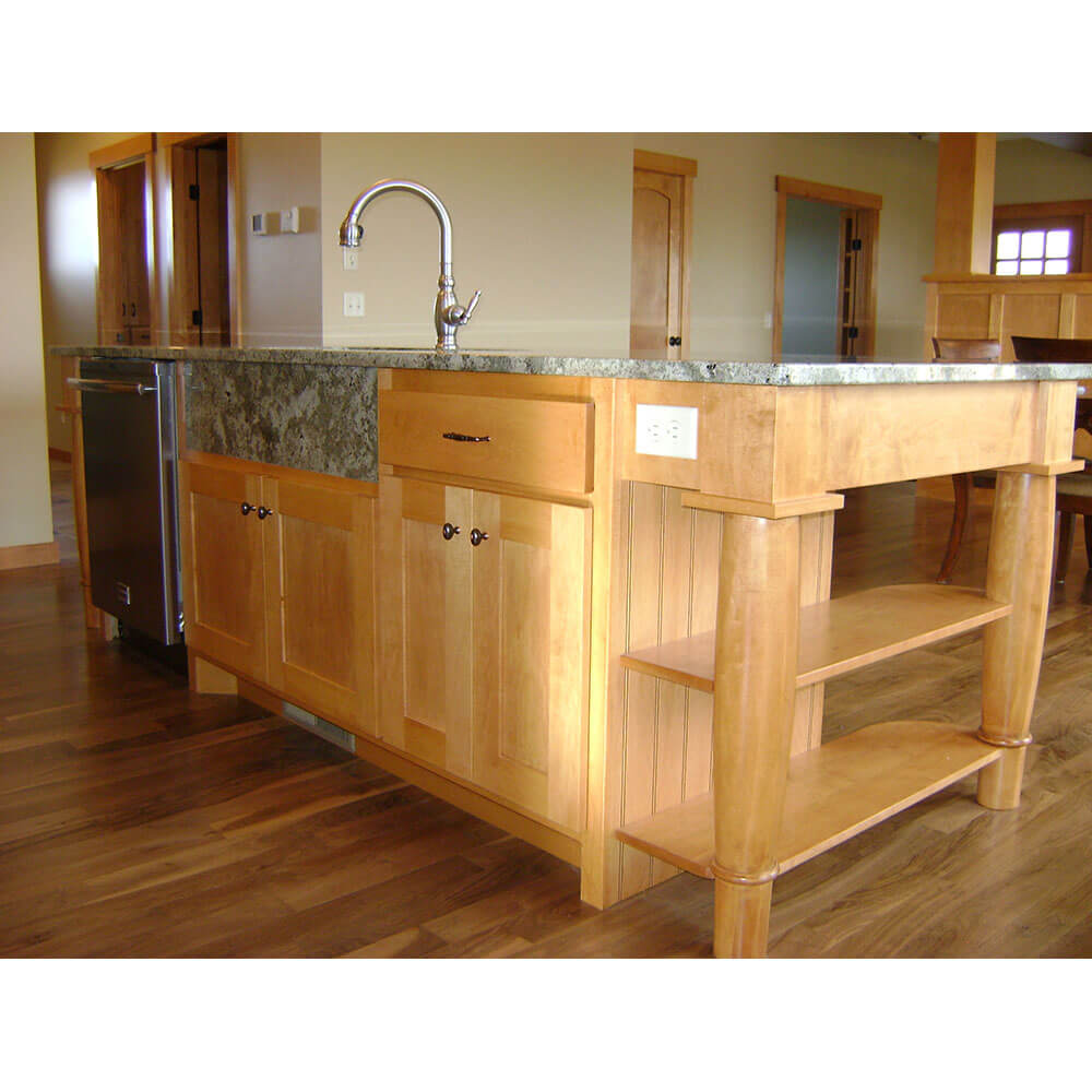 A kitchen island with a granite top and a sink