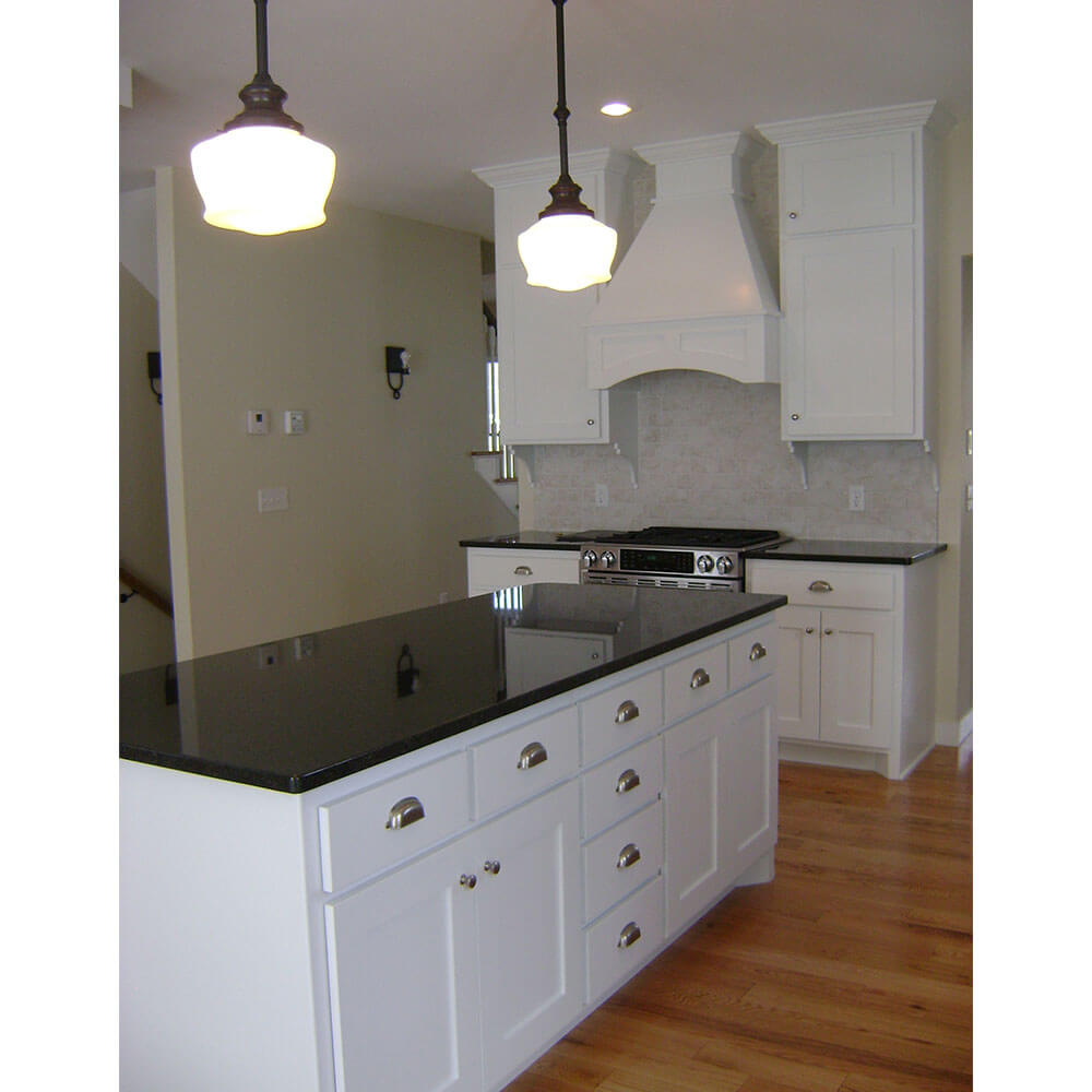 A black counter top on a white kitchen island