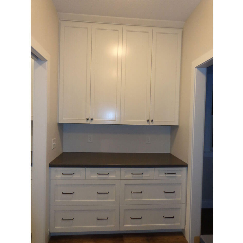 White wooden cabinets in a pantry area