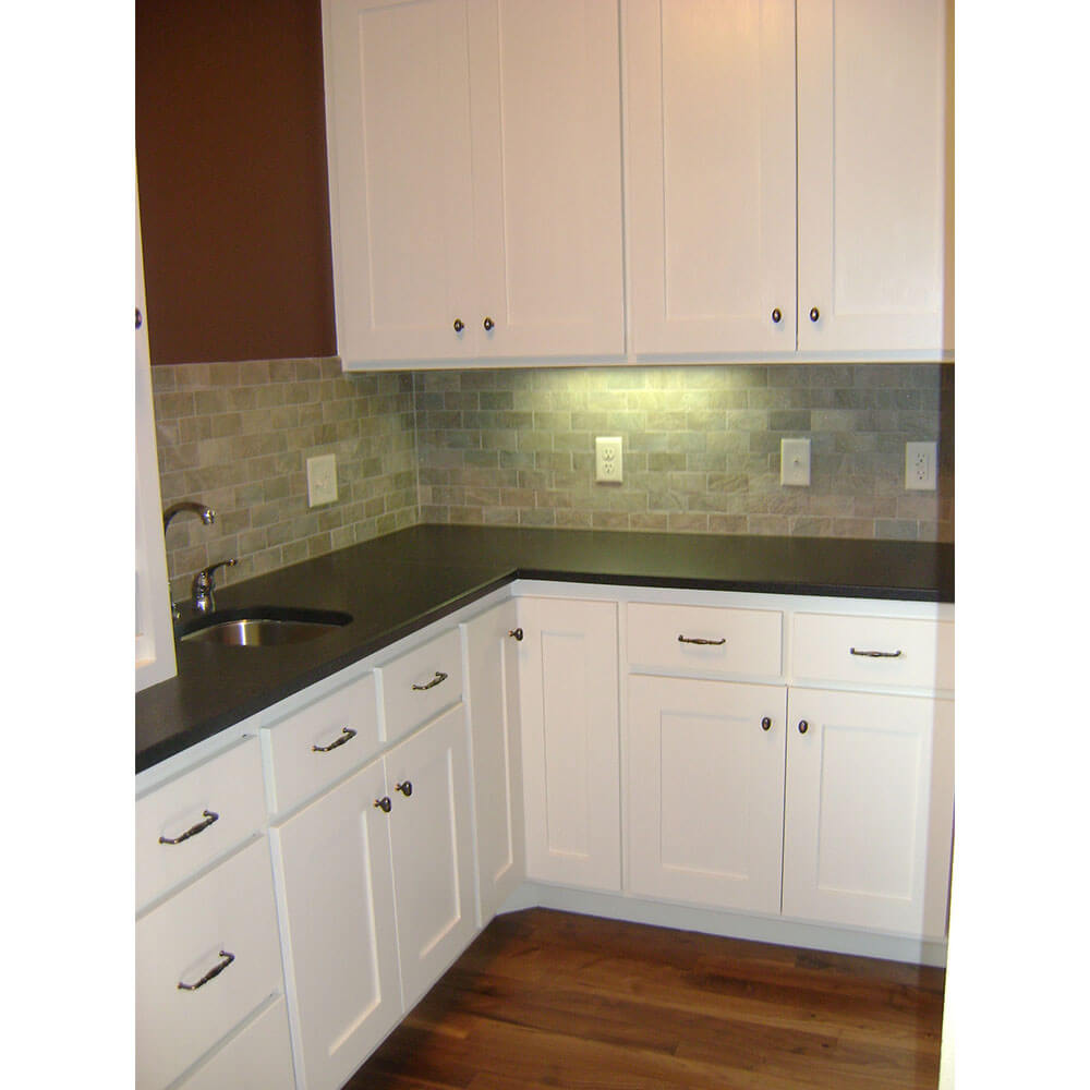 White kitchen cabinets with black countertops
