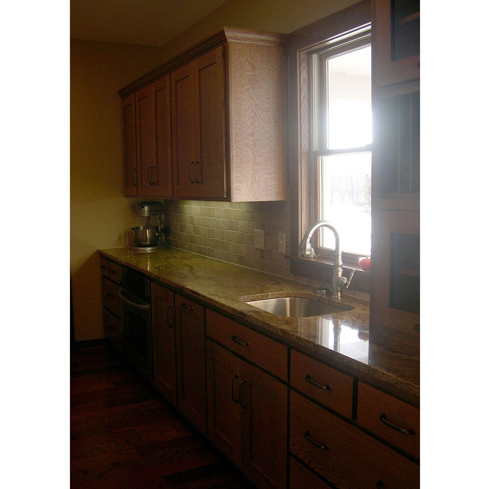 Wood kitchen cabinets with a granite countertop