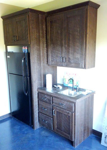 Dark wood kitchen cabinets in a kitchen with a blue floor